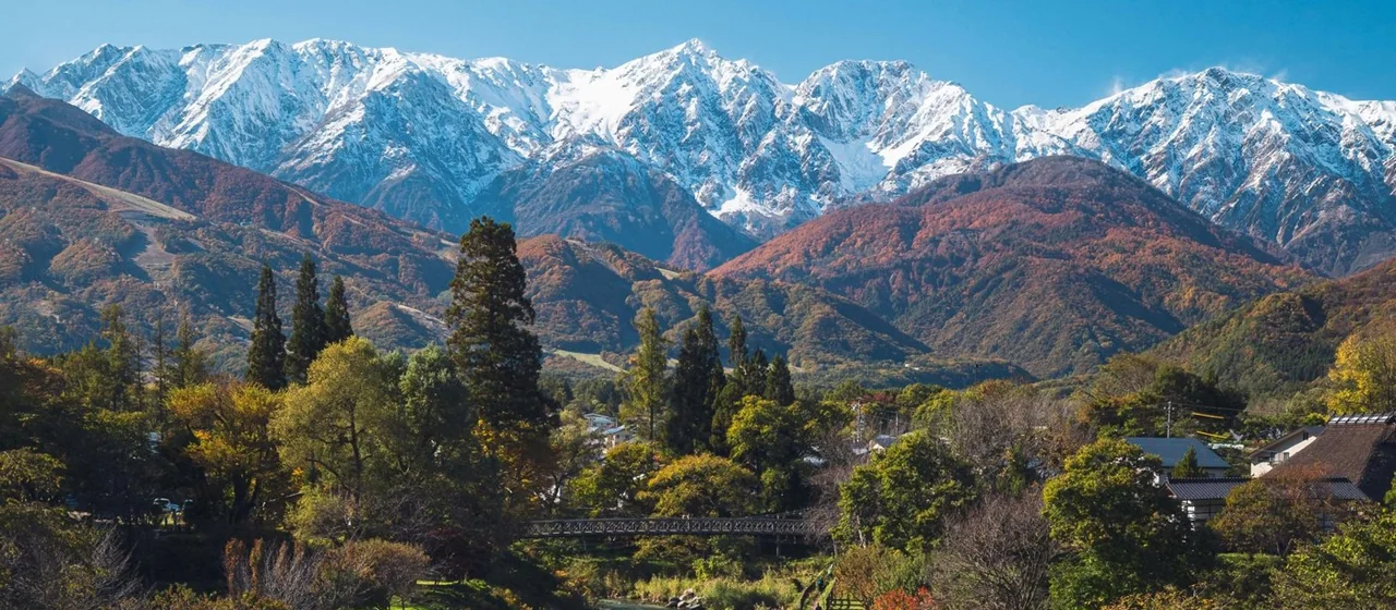 Snow-capped Northern Alps, autumn hills and a riverside view of Hakuba Village (surrounding landscape)