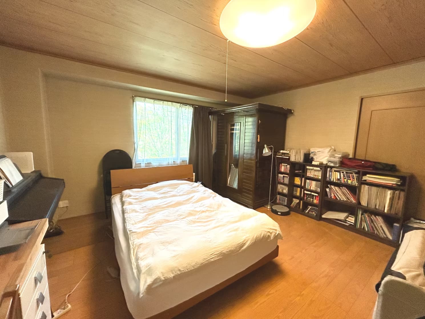 Bedroom with bookshelf and curtains