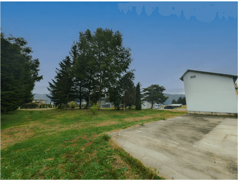 View from the northwest corner of the Hakuba plot, showing flat land and old structure on the southern side