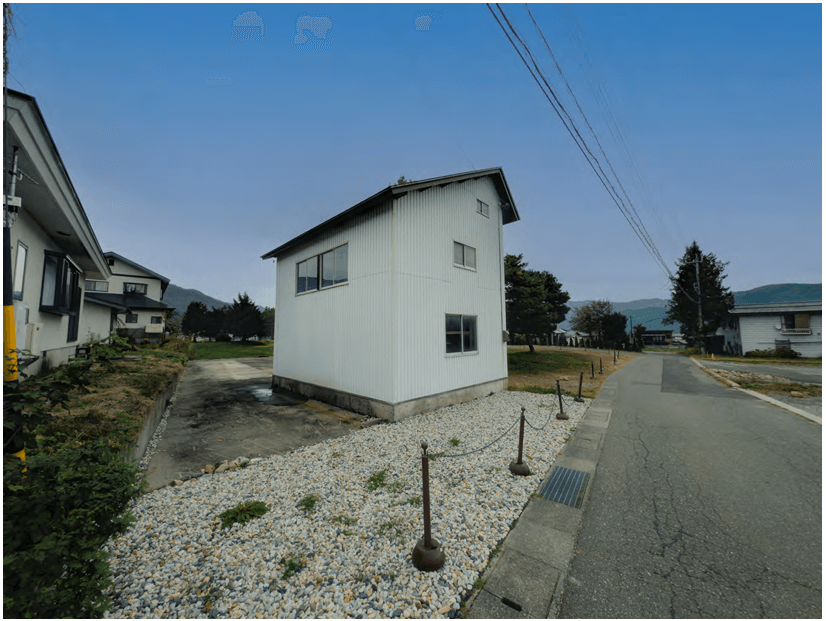 View from the southwest corner of the Hakuba plot, showing the old storehouse and road access