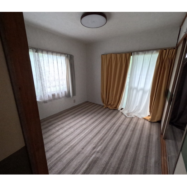 Bedroom with window and beige carpet
