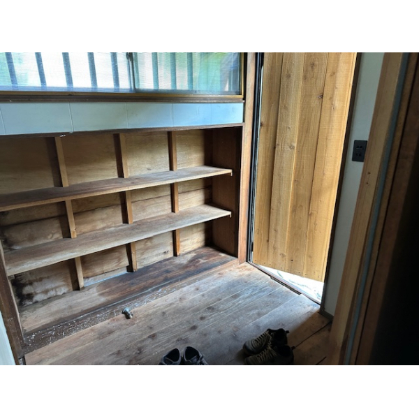 Genkan entrance with wooden shoe storage